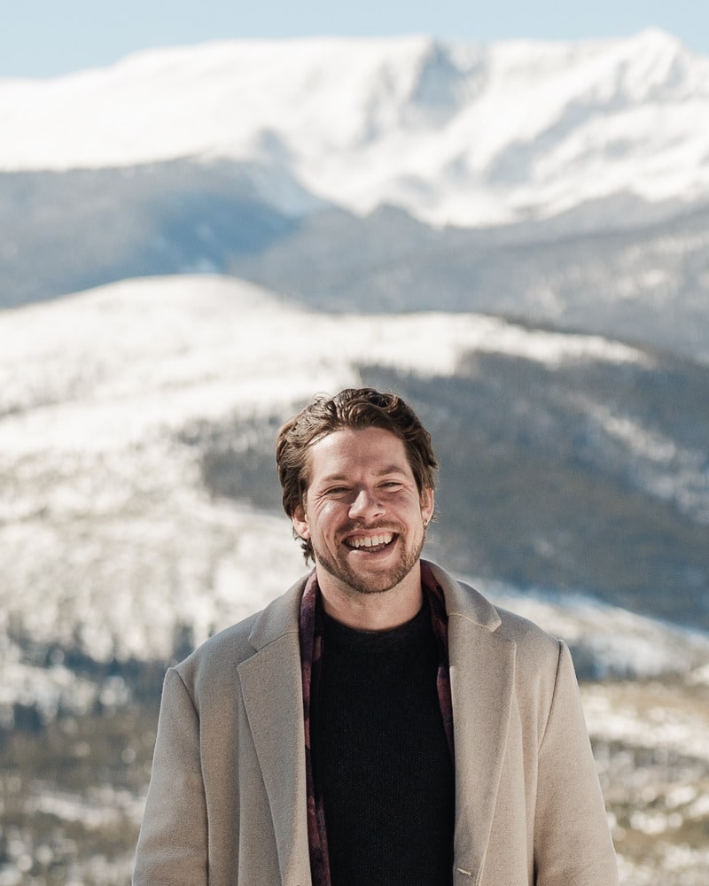 Brandon Thrall smiling outdoors in the Colorado mountains